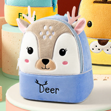 Plush children’s kindergarten backpacks featuring cute animal designs including a ladybug, cow, bunny, tiger, and butterfly, displayed on colorful blocks.