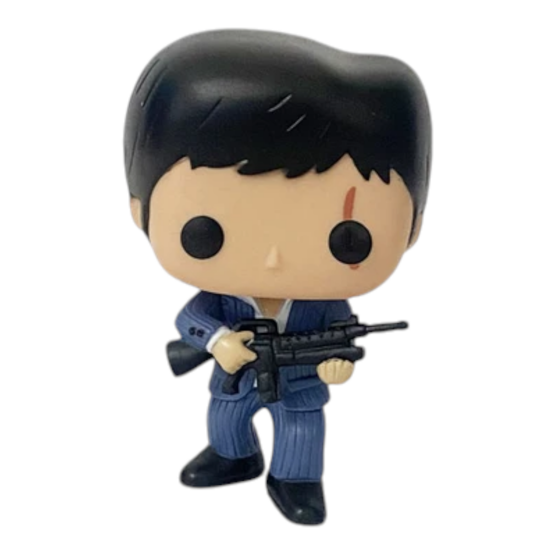 The image shows a Funko Pop! vinyl figure of Tony Montana from the movie "Scarface." The figure is dressed in a blue suit and is holding a rifle. The packaging is also visible, featuring the Pop! Movies logo, the name "Scarface," and the number 86. This collectible is part of the POP Movie Series and is designed for children aged 17 and up. The figure is highly detailed and captures the essence of the iconic character, making it an interesting and relevant item for collectors and fans of the movie.