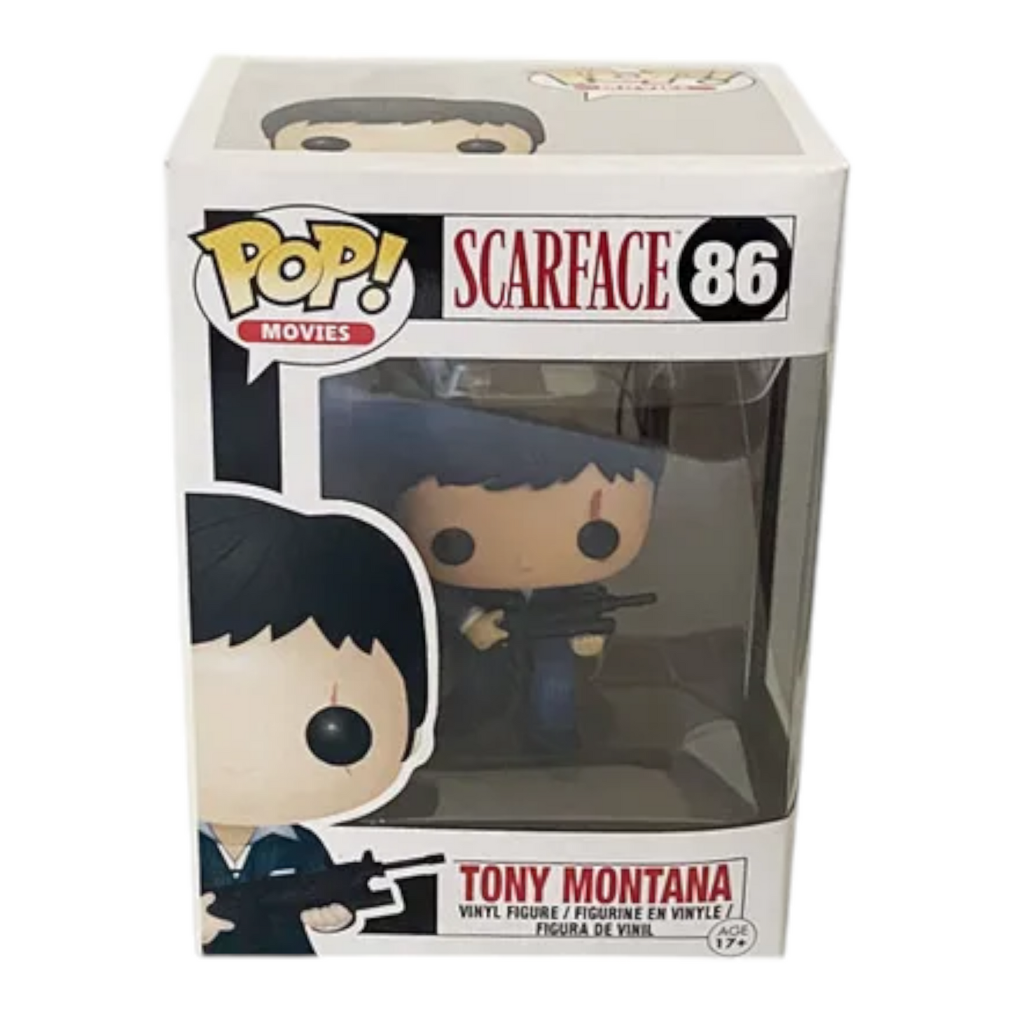 The image shows a Funko Pop! vinyl figure of Tony Montana from the movie "Scarface." The figure is dressed in a blue suit and is holding a rifle. The packaging is also visible, featuring the Pop! Movies logo, the name "Scarface," and the number 86. This collectible is part of the POP Movie Series and is designed for children aged 17 and up. The figure is highly detailed and captures the essence of the iconic character, making it an interesting and relevant item for collectors and fans of the movie.